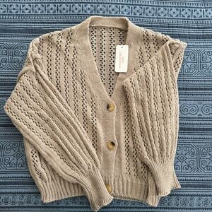 Beige cardigan sweater.